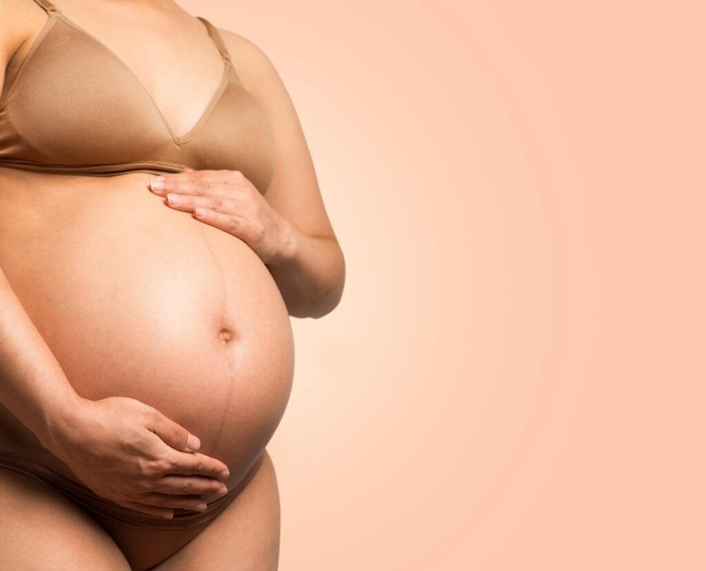 A Pregnant Woman Touching Her Baby Bump