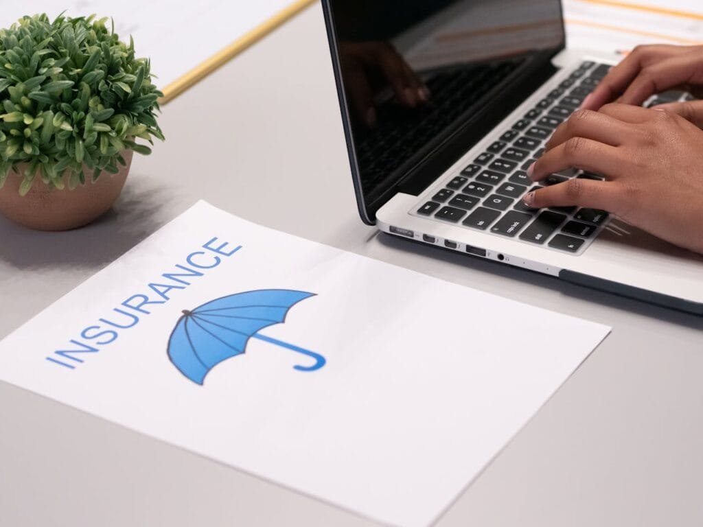 This image is about insurance, specifically umbrella insurance, as indicated by the umbrella graphic and the text on the paper.