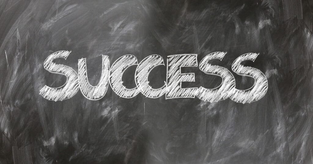 The word "SUCCESS" written on a chalkboard.