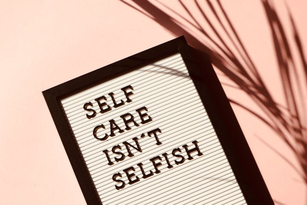 A letter board with the quote:
"SELF CARE ISN'T SELFISH"