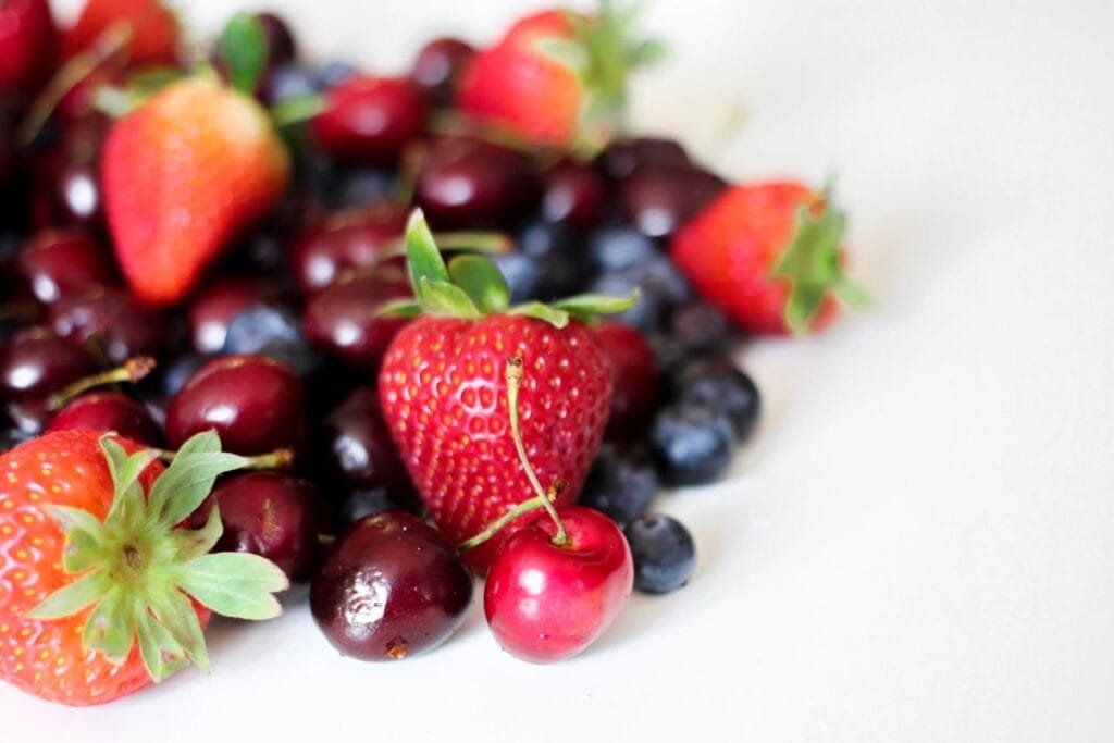 A variety of berries, including strawberries, blueberries, and cherries.